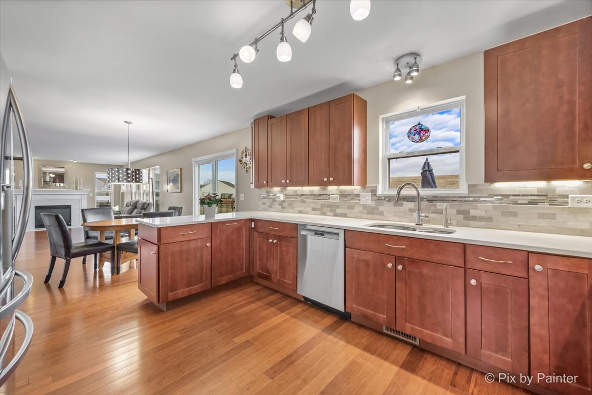 4902 Stillwater Road Wonder Lake, IL 60097 - Photo 10 of 46 a kitchen with granite countertop a sink cabinets and wooden floor