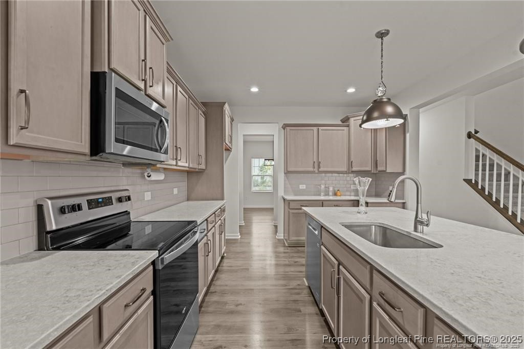 40 Arlie Lane Lillington, NC 27546 - Photo 14 of 39 a kitchen with stainless steel appliances granite countertop a sink stove and refrigerator