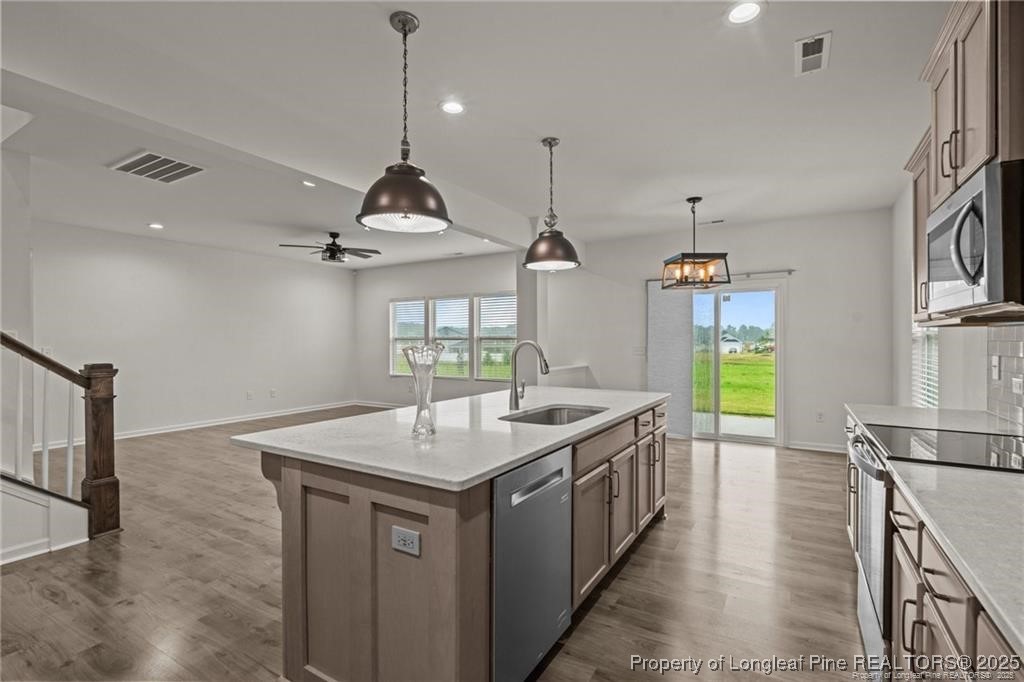 40 Arlie Lane Lillington, NC 27546 - Photo 16 of 39 a kitchen with a sink a counter space appliances and cabinets