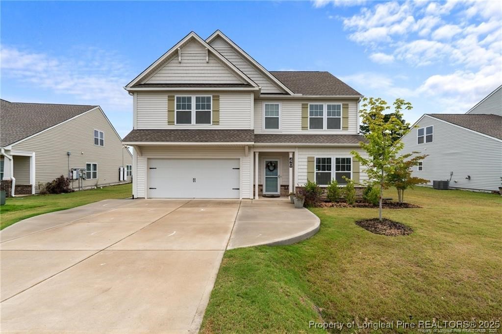 40 Arlie Lane Lillington, NC 27546 - Photo 2 of 39 a front view of a house with yard and garage