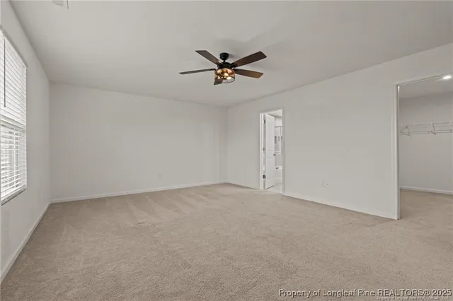 a bathroom with double vanity sinks and a shower
