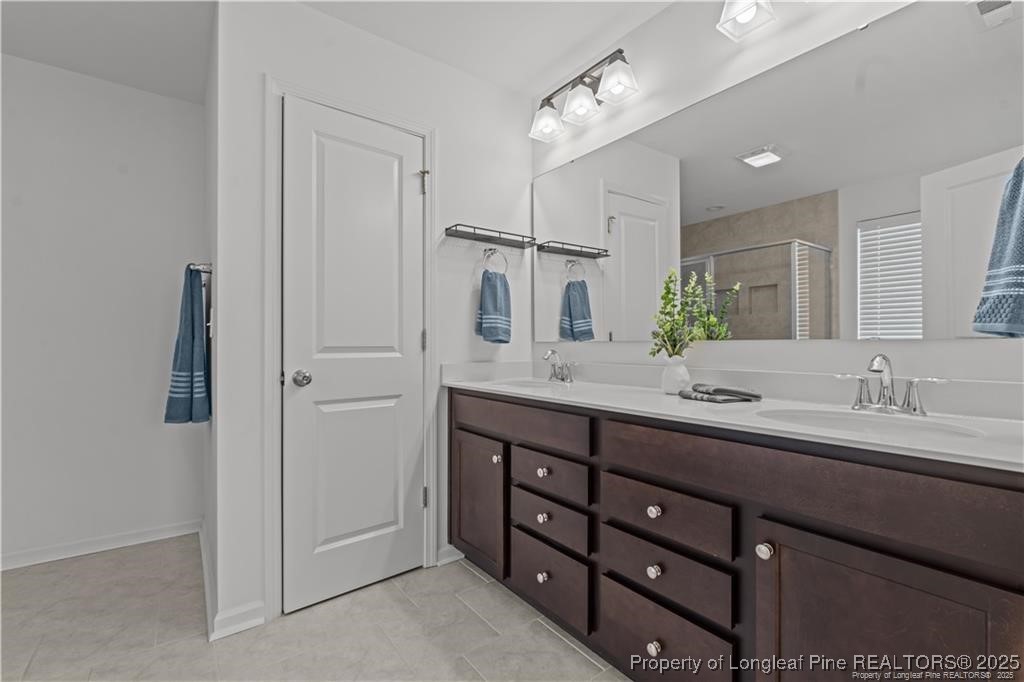 40 Arlie Lane Lillington, NC 27546 - Photo 24 of 39 a bathroom with double vanity sinks and a shower