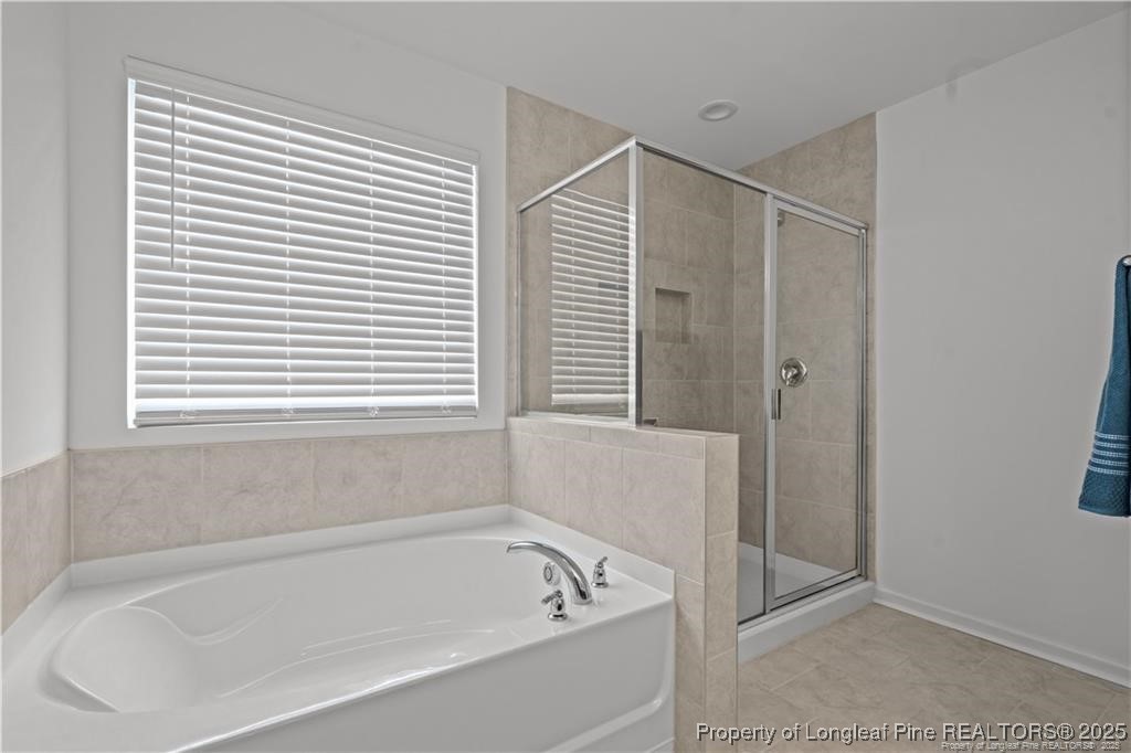 40 Arlie Lane Lillington, NC 27546 - Photo 25 of 39 a bathroom with a bathtub and a shower