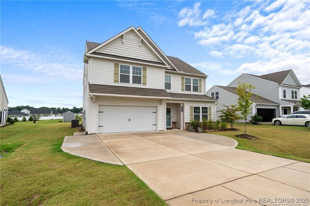 40 Arlie Lane Lillington, NC 27546 - Photo 3 of 39 a front view of a house with a garden