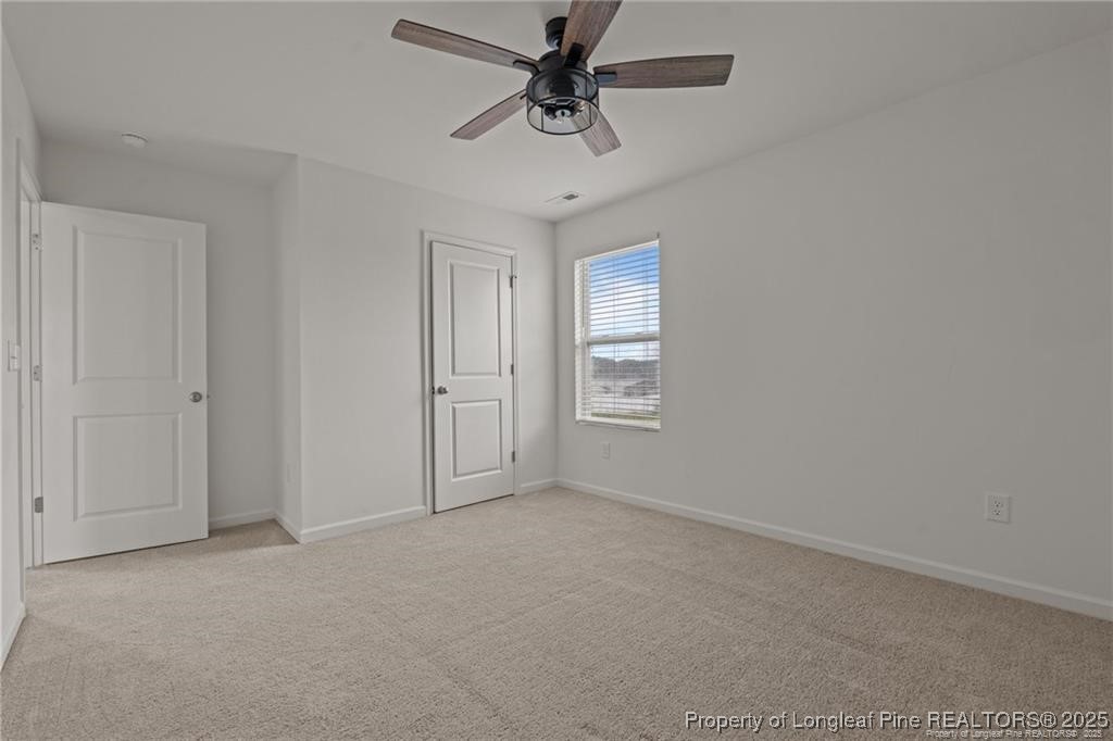 40 Arlie Lane Lillington, NC 27546 - Photo 31 of 39 an empty room with windows and fan