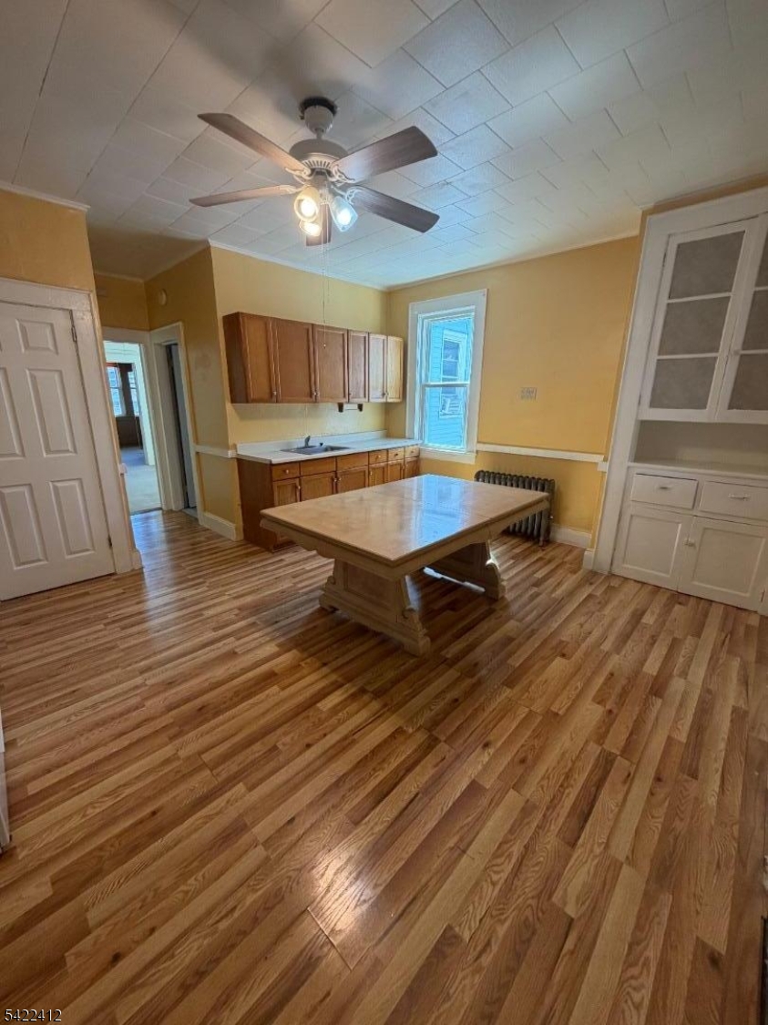 656 North 7th Street, Unit L2 Newark, NJ 07107 - Photo 4 of 12 a living room with a table kitchen view and wooden floor