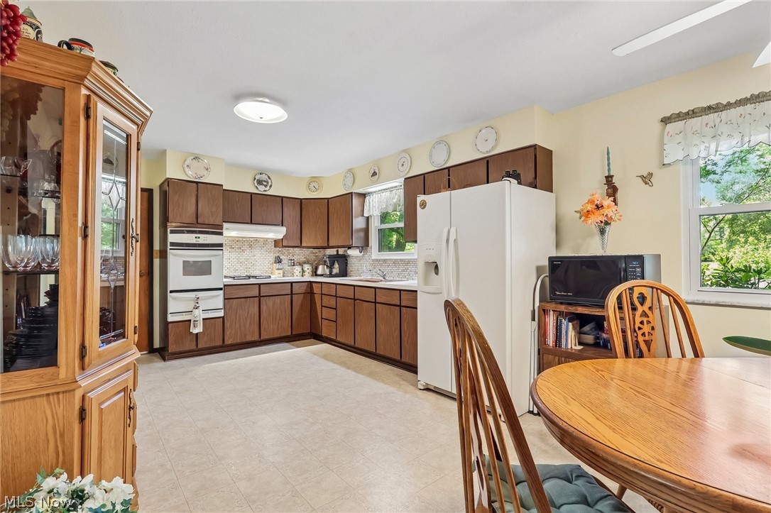 2428 Antioch Road Perry, OH 44081 - Photo 22 of 46 Expansive kitchen featuring wood-finish cabinetry, a built-in oven, and a patterned backsplash