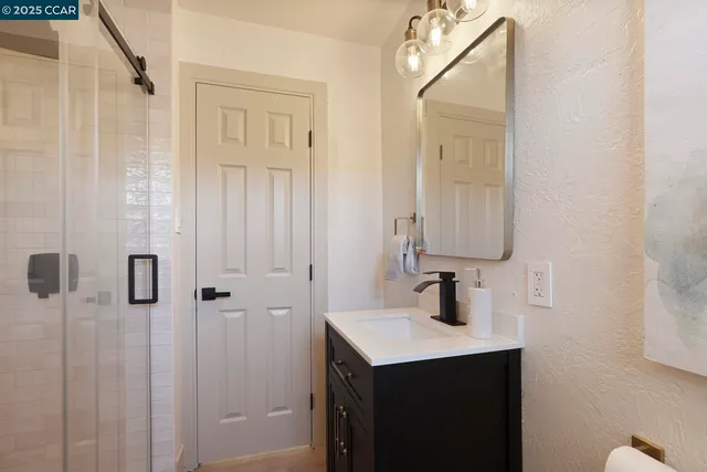 a bathroom with a sink a mirror and shower