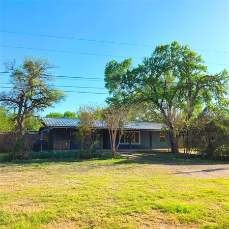 a house view with swimming pool in front of it