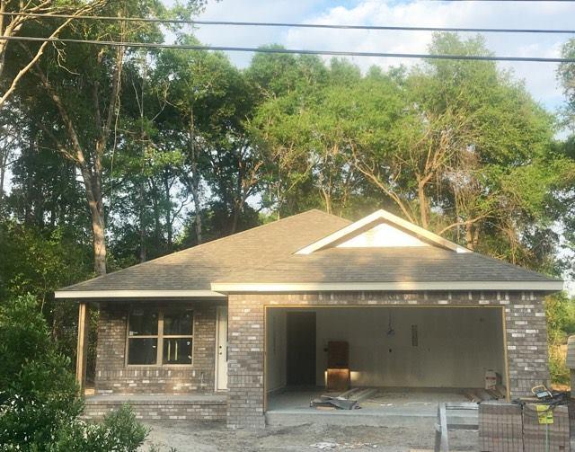 976 Valley Road Crestview, FL 32539 - Photo 1 of 26 a front view of a house with a yard and garage
