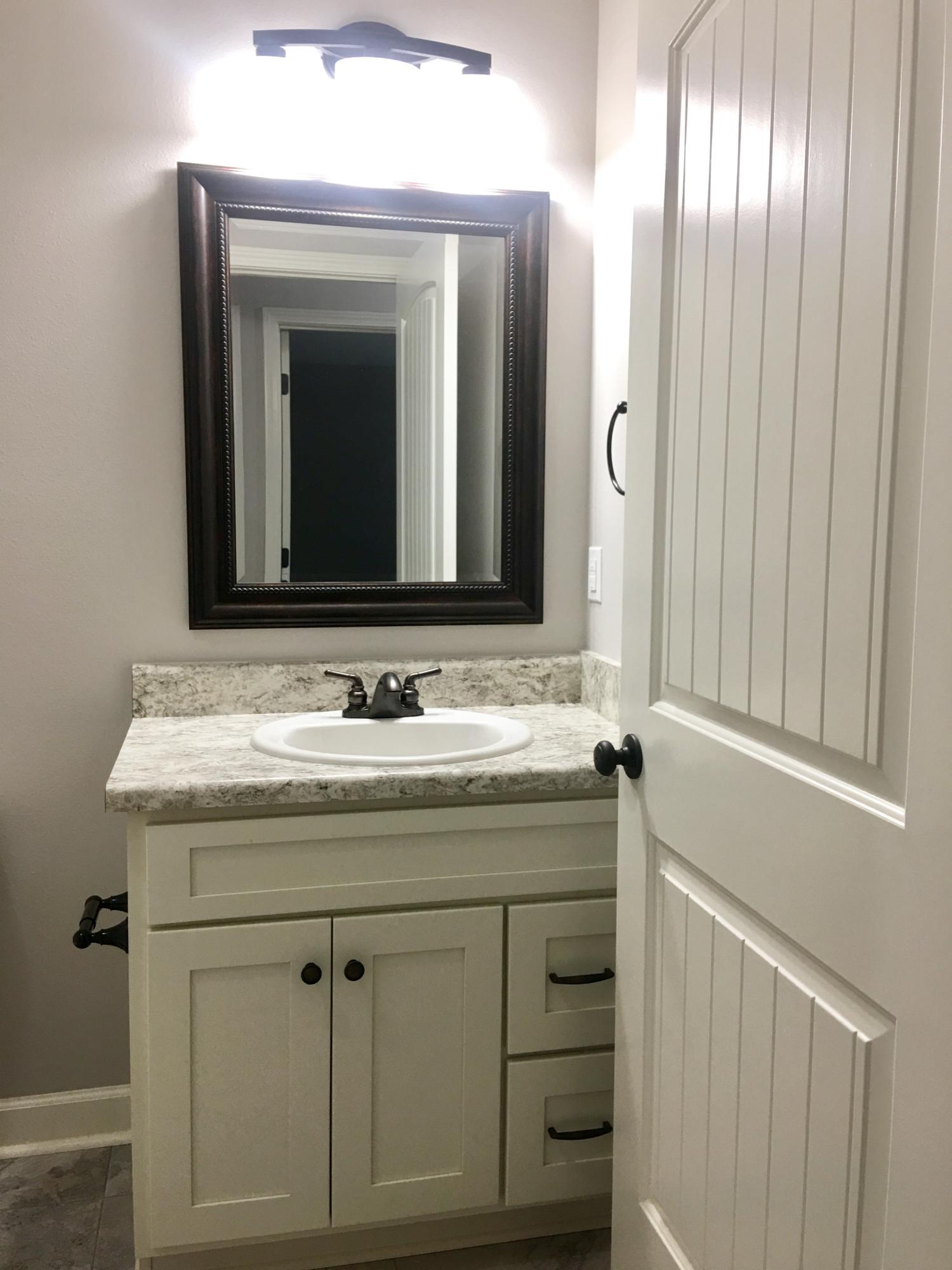 976 Valley Road Crestview, FL 32539 - Photo 11 of 26 a bathroom with a granite countertop sink and a mirror