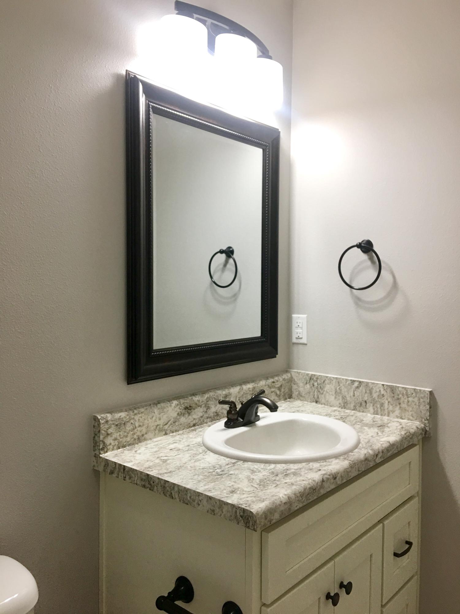 976 Valley Road Crestview, FL 32539 - Photo 12 of 26 a bathroom with a granite countertop sink and a mirror