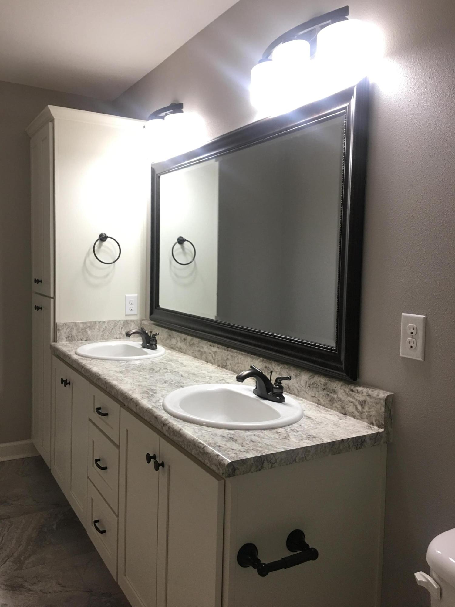 976 Valley Road Crestview, FL 32539 - Photo 18 of 26 a bathroom with a granite countertop sink and a mirror