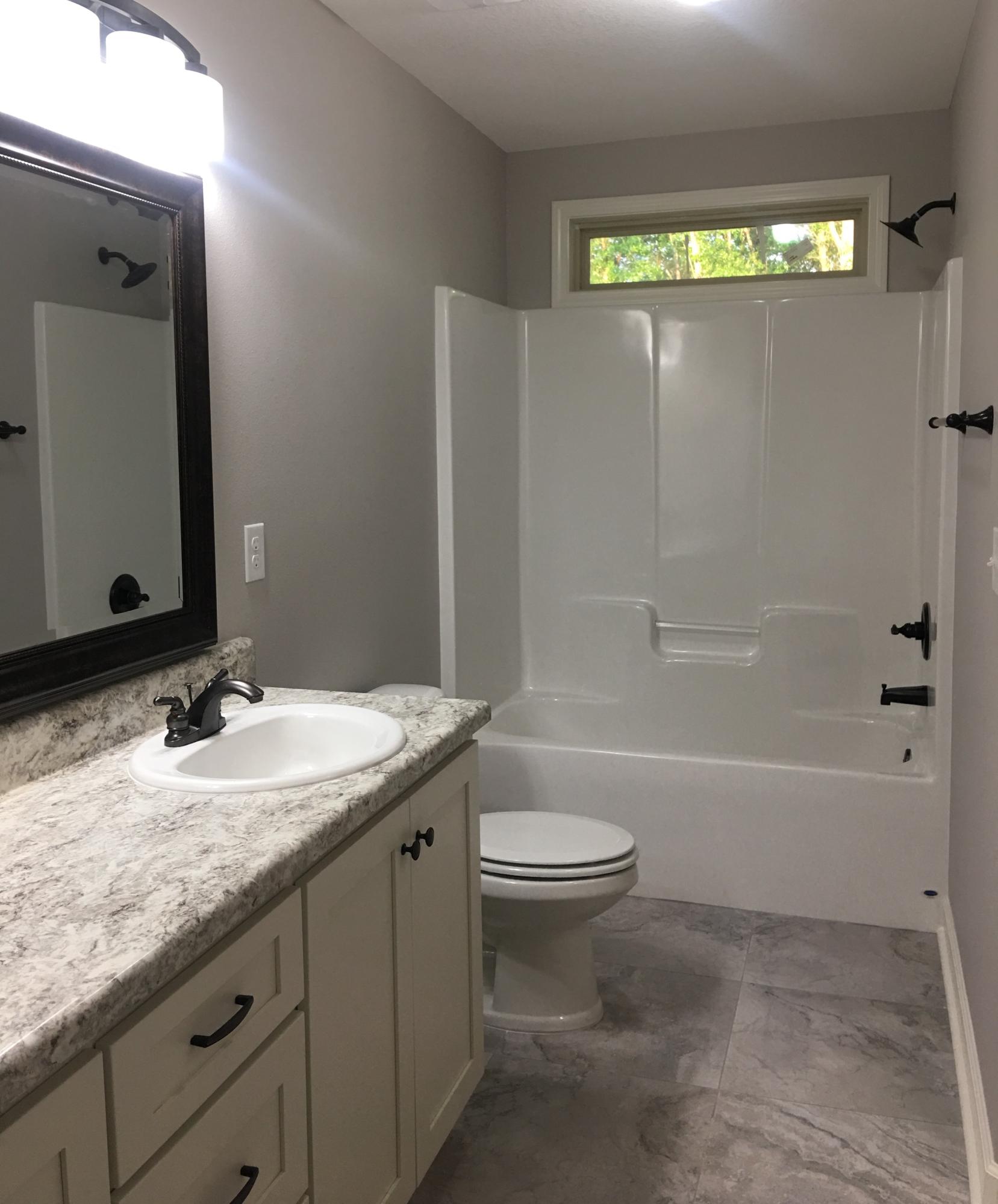 976 Valley Road Crestview, FL 32539 - Photo 19 of 26 a bathroom with a granite countertop sink toilet and shower