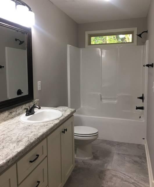 976 Valley Road Crestview, FL 32539 - Photo 25 of 26 a bathroom with a granite countertop sink toilet and shower