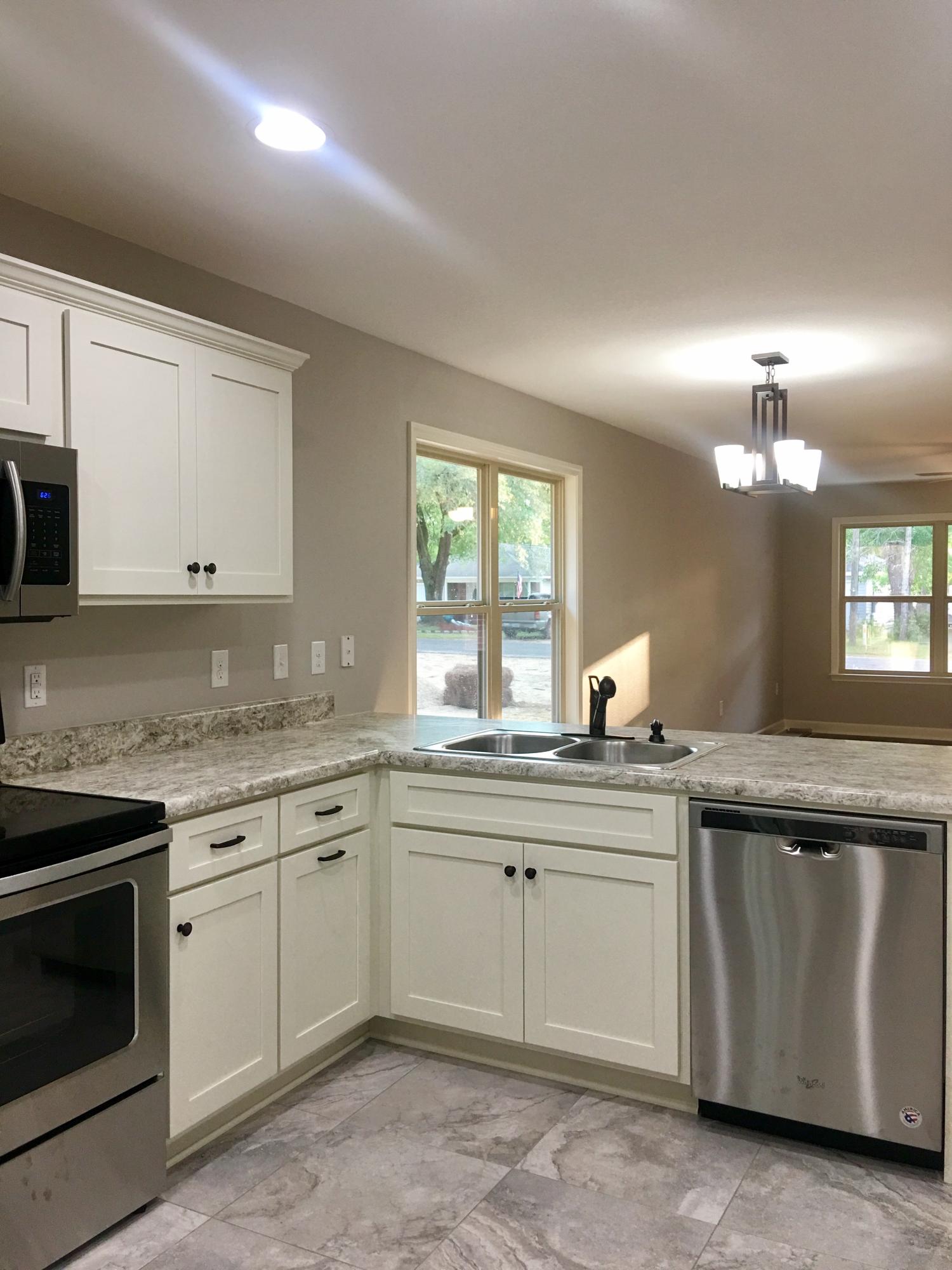 976 Valley Road Crestview, FL 32539 - Photo 5 of 26 a kitchen with a sink and cabinets