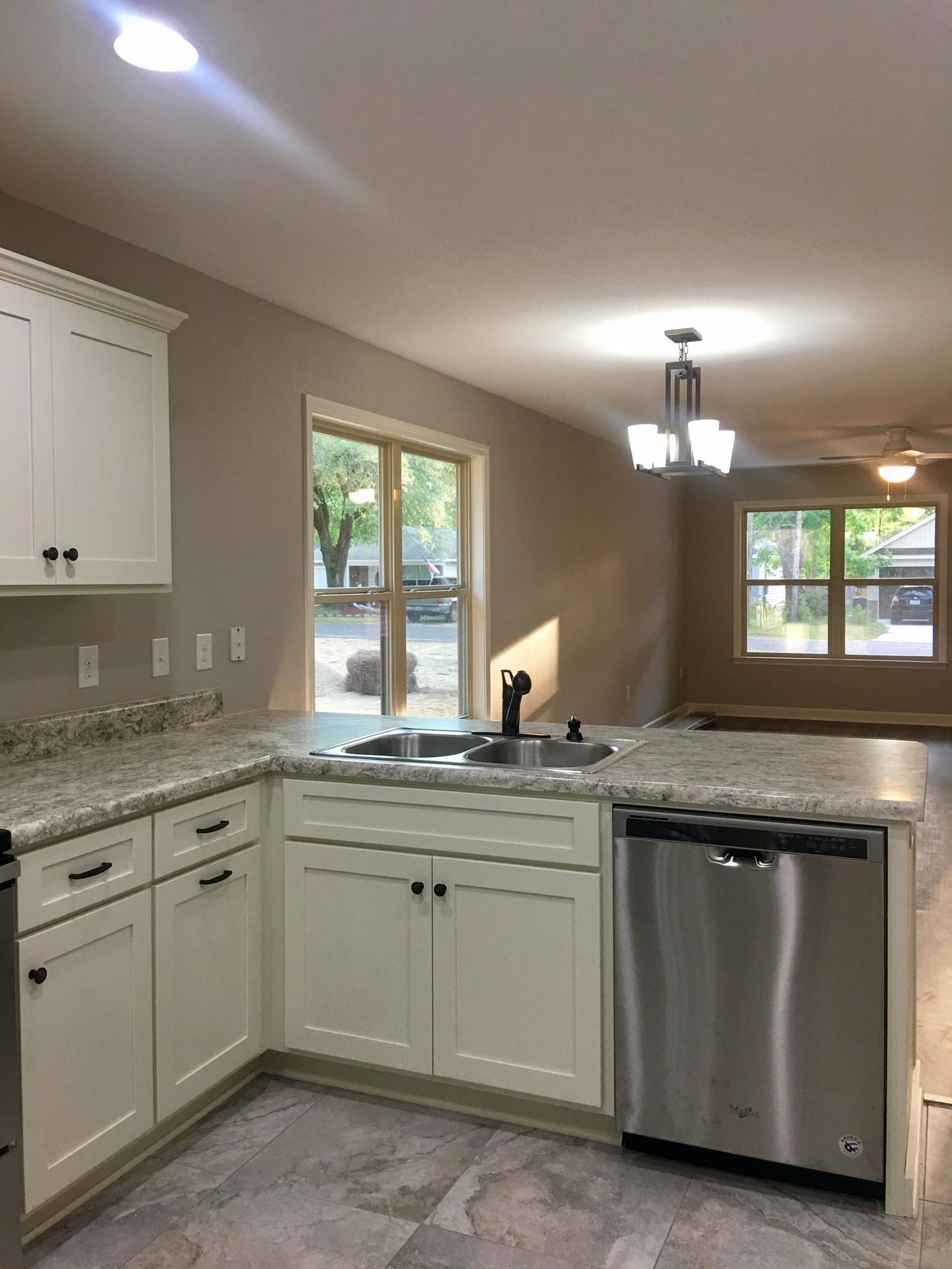 976 Valley Road Crestview, FL 32539 - Photo 6 of 26 a kitchen with granite countertop white cabinets and a sink