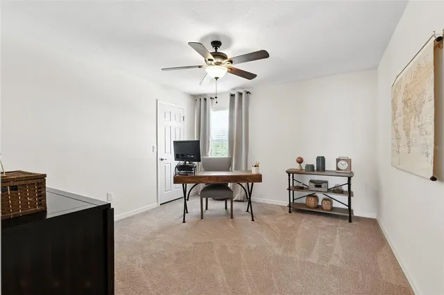 a view of a livingroom with furniture and workspace