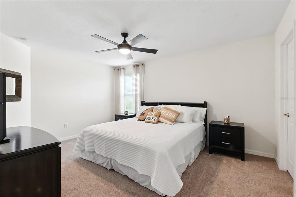 1653 Nature View Drive Lutz, FL 33558 - Photo 26 of 63 a bedroom with a bed and a desk