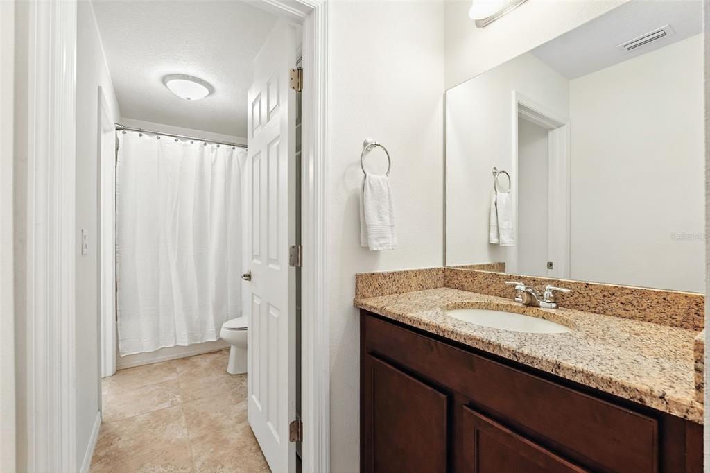 1653 Nature View Drive Lutz, FL 33558 - Photo 31 of 63 a bathroom with a granite countertop sink and a mirror