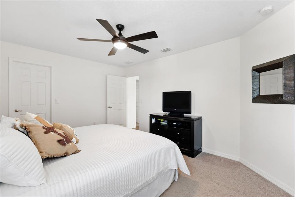 1653 Nature View Drive Lutz, FL 33558 - Photo 33 of 63 a bedroom with a bed and a flat screen tv