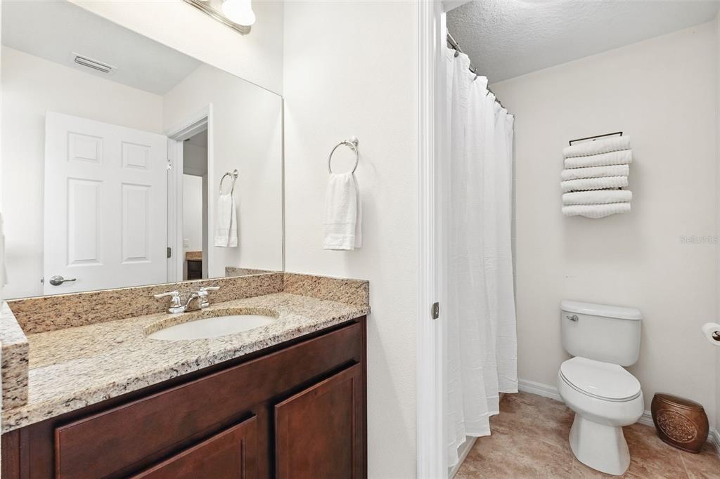 1653 Nature View Drive Lutz, FL 33558 - Photo 34 of 63 a bathroom with a granite countertop sink toilet and shower