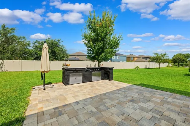 a view of backyard with seating area and green space