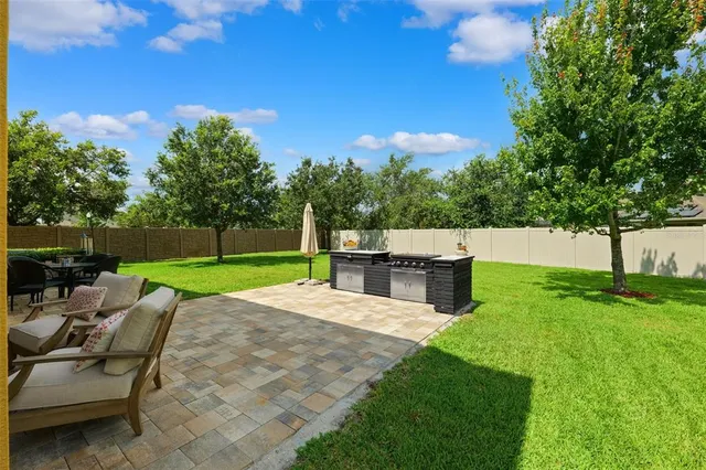 a view of a fountain in front of a house with a big yard