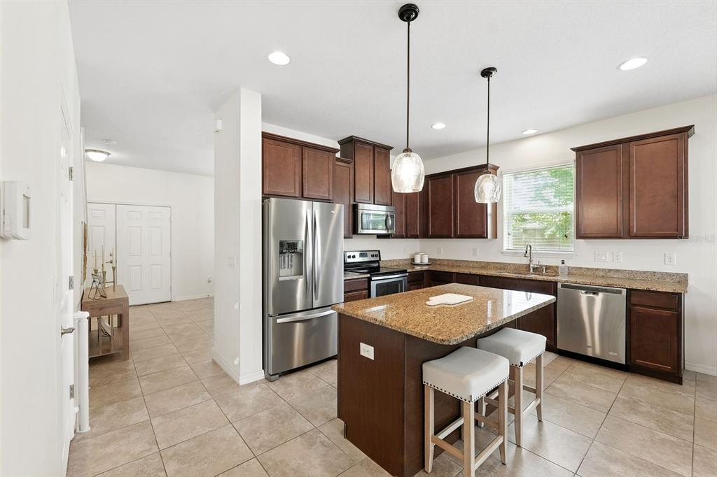 1653 Nature View Drive Lutz, FL 33558 - Photo 7 of 63 a kitchen with stainless steel appliances granite countertop a sink a stove a refrigerator and island