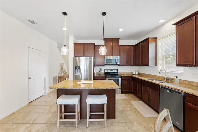 a kitchen with a table and chairs in it