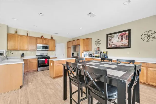a view of a dining room with furniture and a kitchen