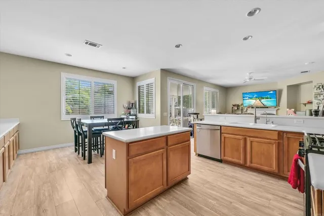 a kitchen with a stove a sink and a refrigerator