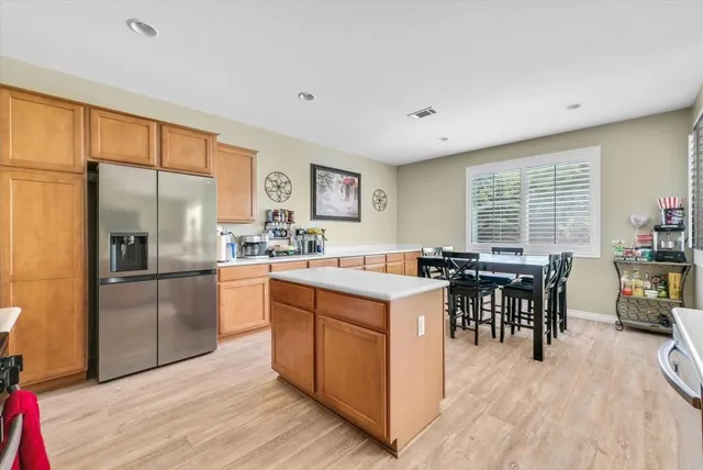 a kitchen with stainless steel appliances granite countertop sink stove top oven and cabinets