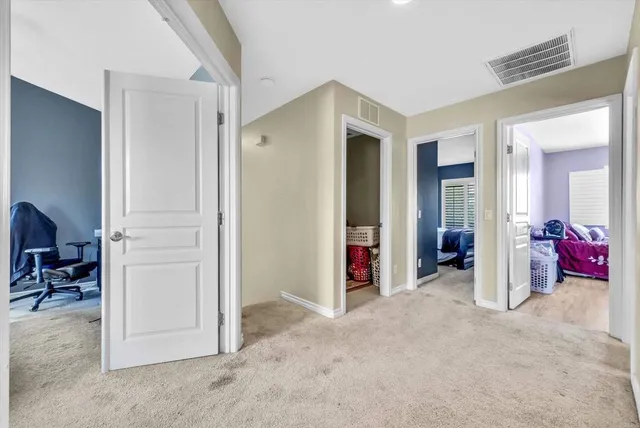a bedroom with a bed a couch and a chandelier