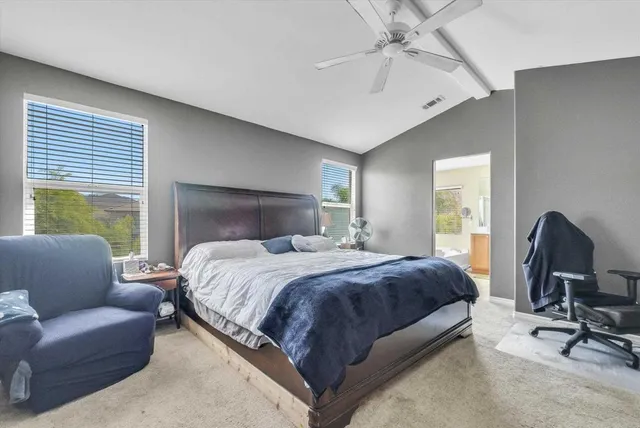 a bedroom with bed and a chandelier