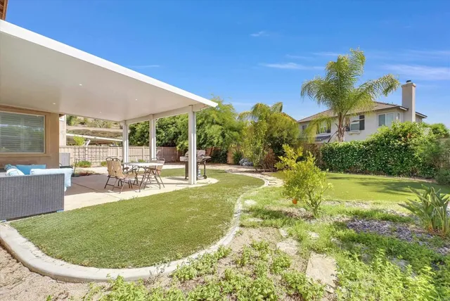 a view of a house with a big yard and potted plants