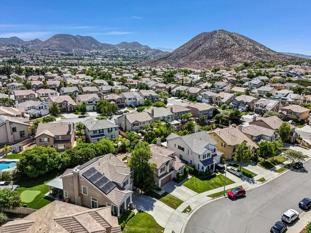 an aerial view of a houses with a street