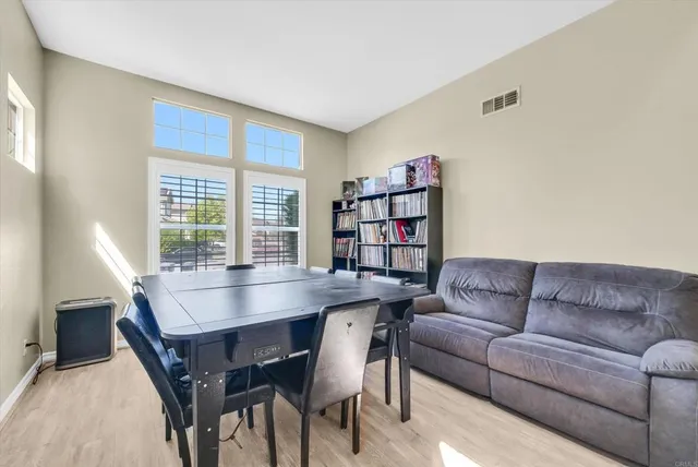 a living room with furniture and a book shelf