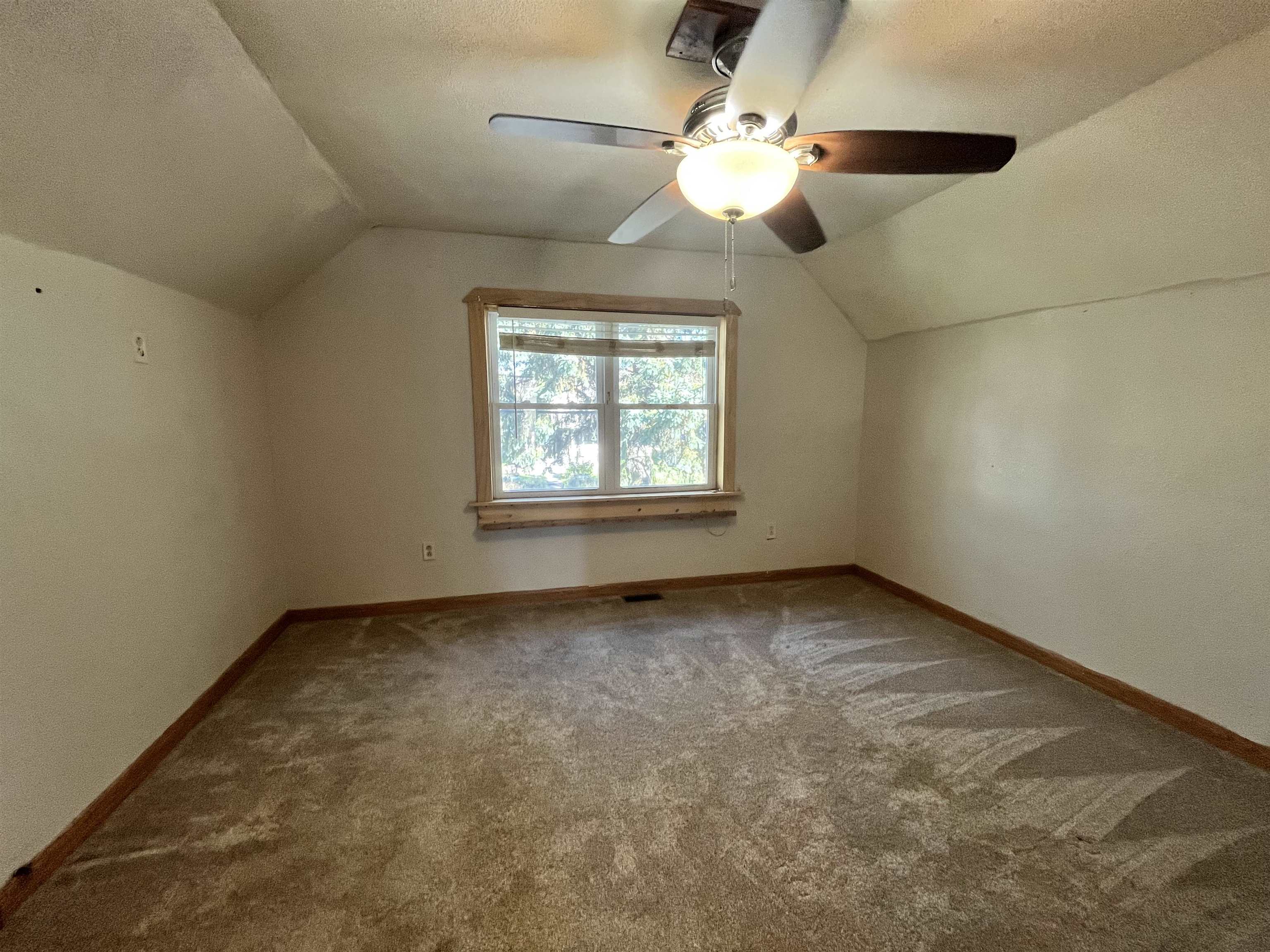 14 3rd Street Proctor, MN 55810 - Photo 12 of 19 Additional living space with lofted ceiling, carpet flooring, and a textured ceiling