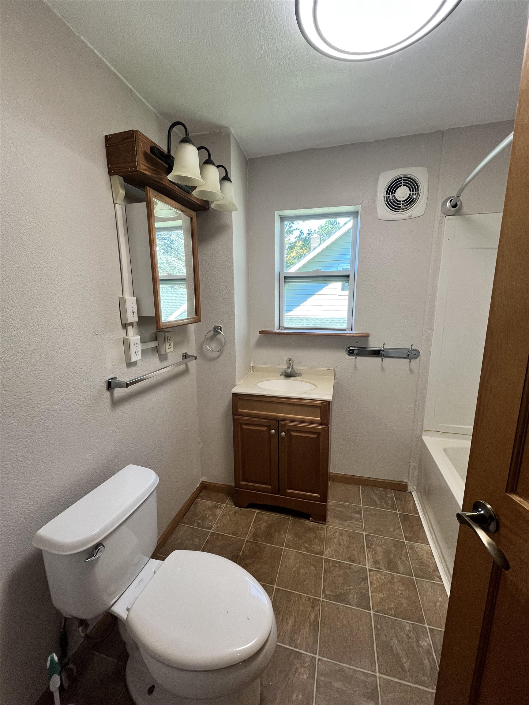 14 3rd Street Proctor, MN 55810 - Photo 13 of 19 Full bathroom featuring shower combination, vanity, and a textured ceiling