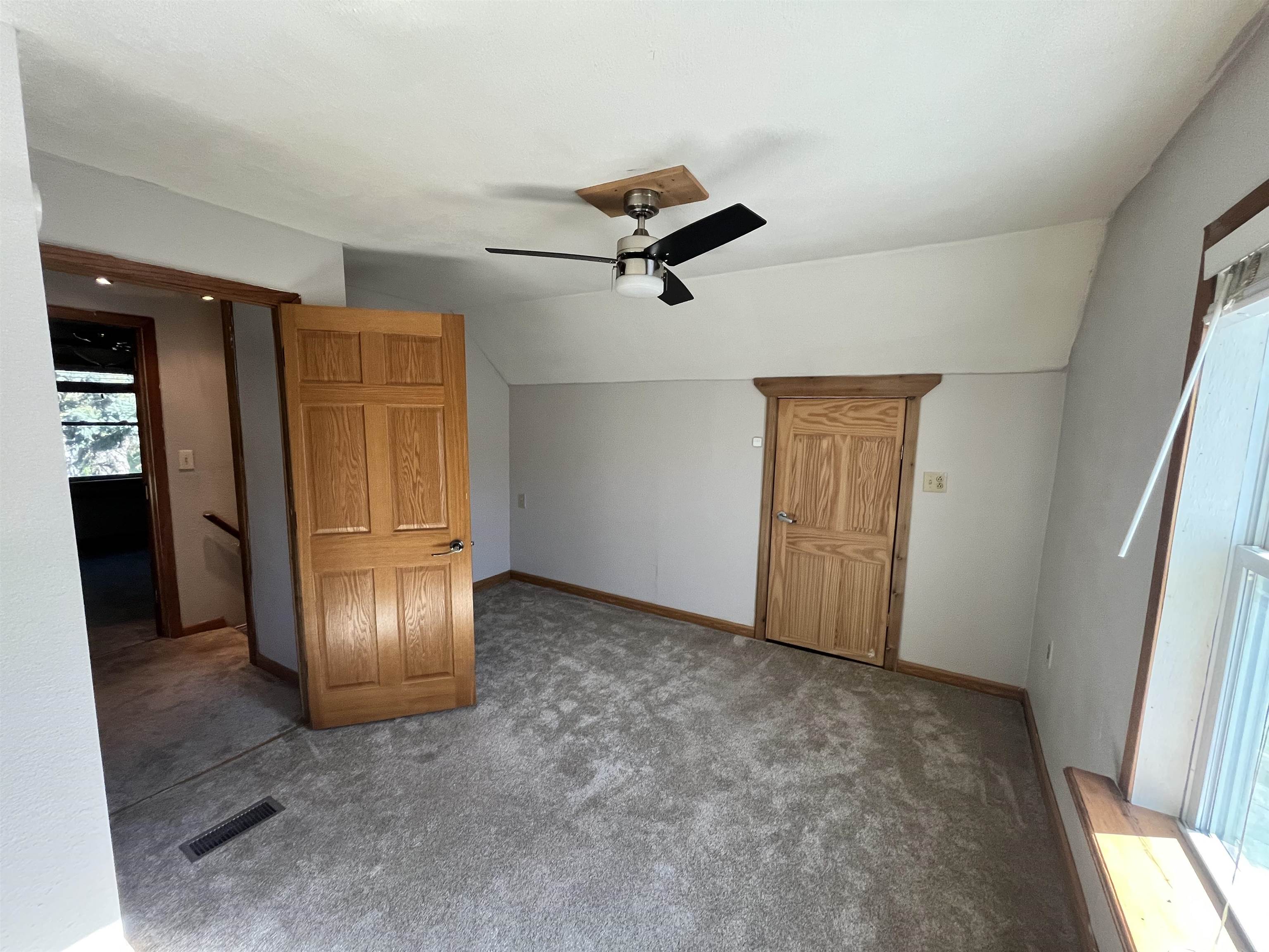 14 3rd Street Proctor, MN 55810 - Photo 14 of 19 Unfurnished bedroom with carpet floors, lofted ceiling, and ceiling fan