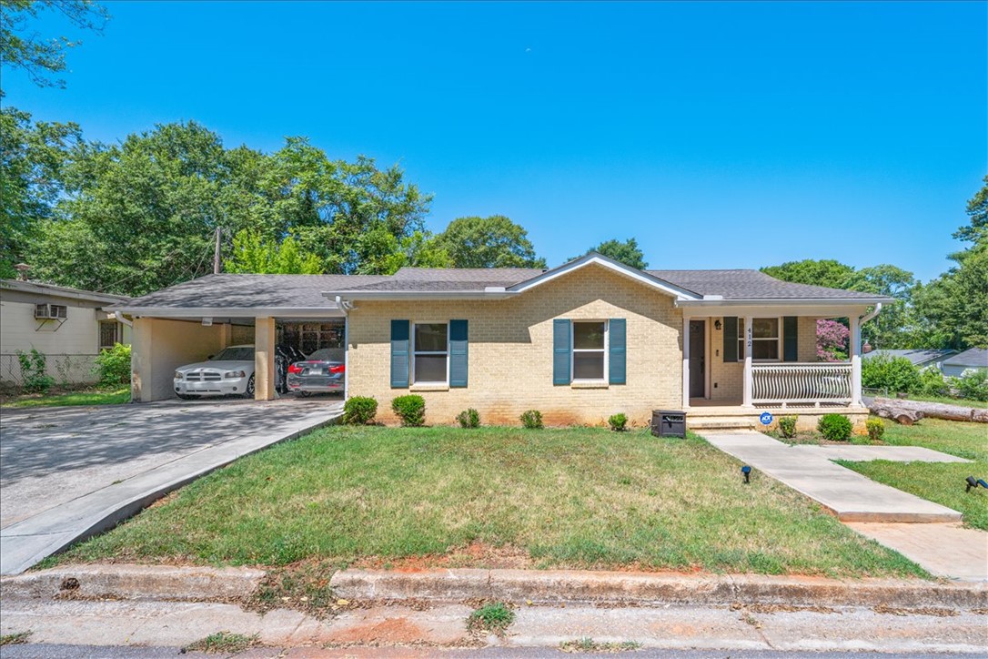 412 Sanders Street Anderson, SC 29624 - Photo 1 of 30 A charming brick home welcomes with a covered front porch and convenient carport.