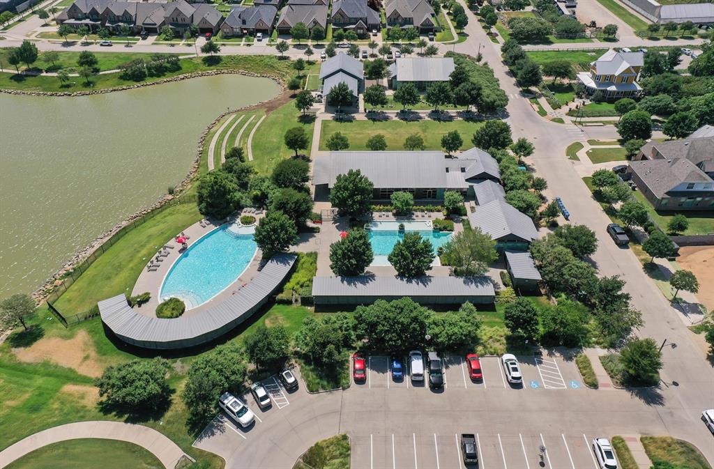 421 Matchbox Street Argyle, TX 76226 - Photo 36 of 40 Aerial view of a community featuring two swimming pools, a large body of water, extensive green spaces, and dedicated parking areas