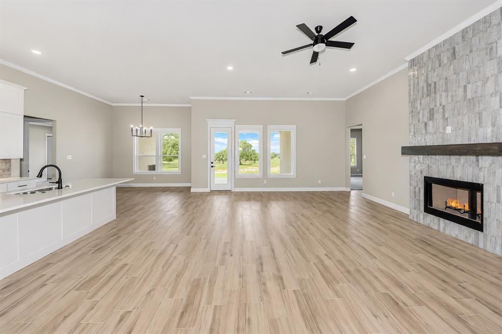 1057 Vh Ranch Poolville, TX 76487 - Photo 7 of 38 wooden floor in an empty room with a window