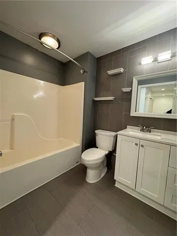 a bathroom with a toilet a sink and bathtub