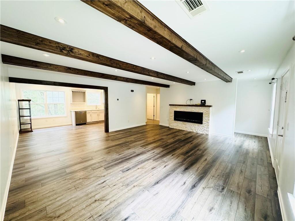 420 Old Holcomb Bridge Road Roswell, GA 30076 - Photo 9 of 30 a view of empty room with wooden floor and fireplace