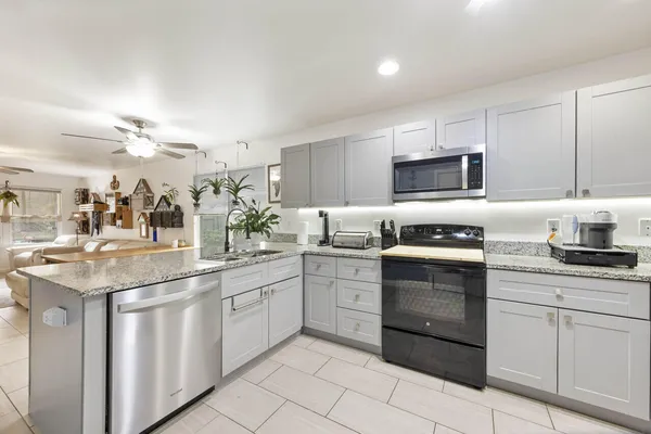 a kitchen with stainless steel appliances a refrigerator sink and cabinets