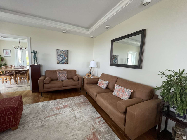 7030 West 2100 North Mendon, UT 84325 - Photo 22 of 67 Living area featuring warm wood-finish flooring, recessed lighting, and crown molding