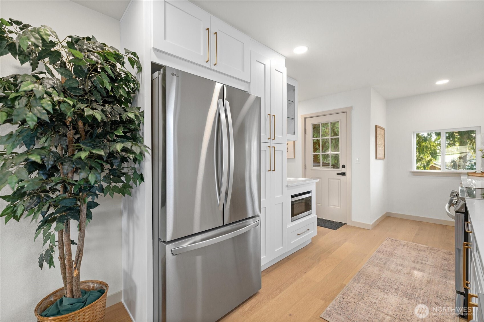 3711 Southwest Webster Street Seattle, WA 98126 - Photo 12 of 39 a kitchen with stainless steel appliances a refrigerator and a plant