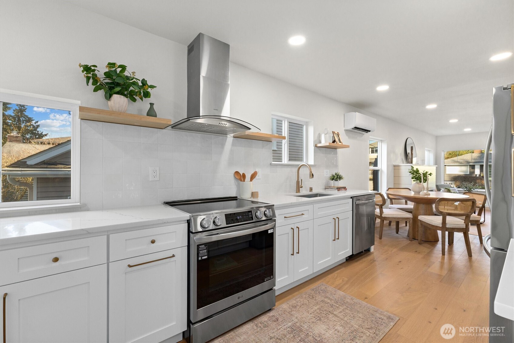 3711 Southwest Webster Street Seattle, WA 98126 - Photo 14 of 39 a kitchen with stainless steel appliances a stove a sink cabinets and a wooden floor